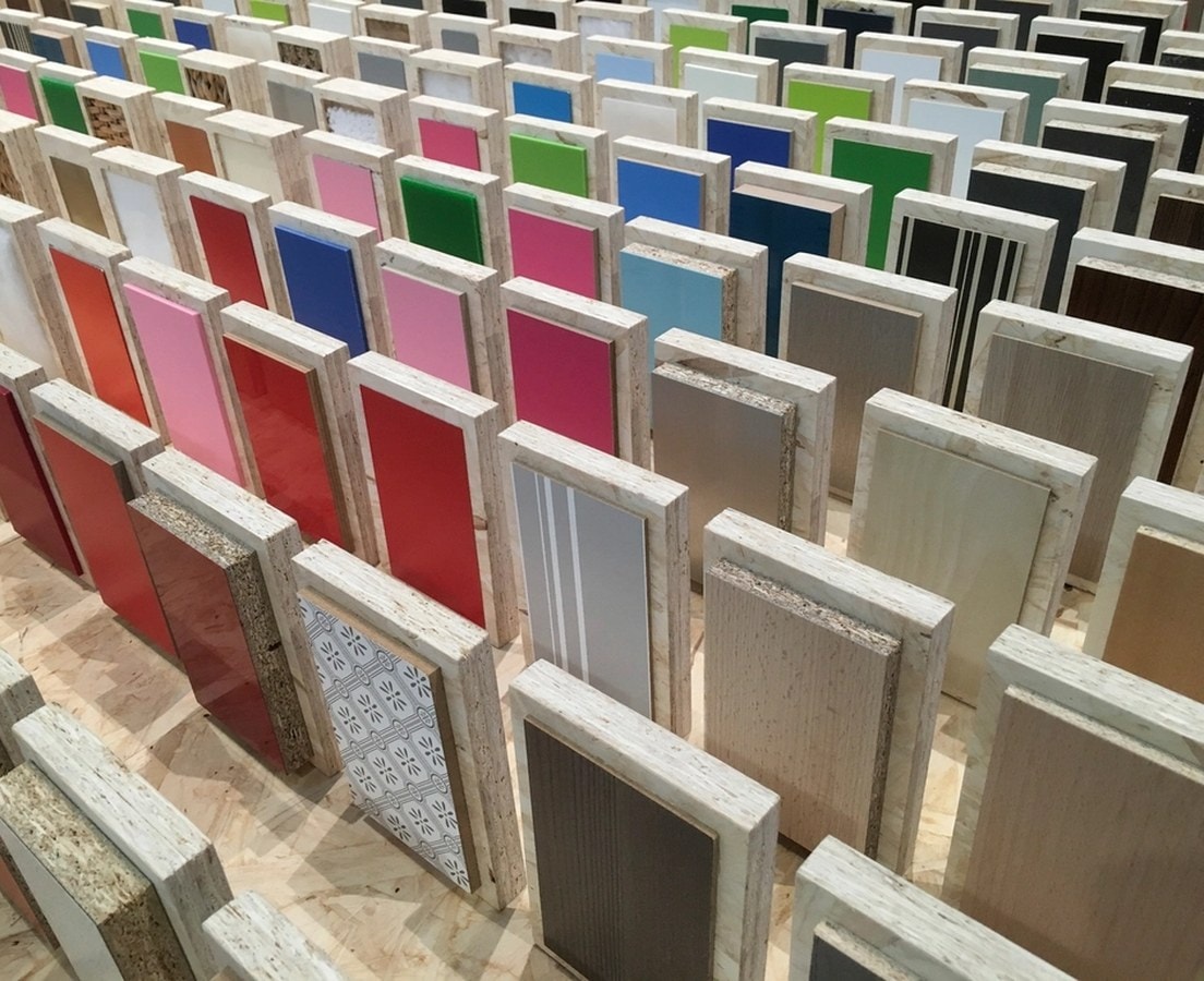 Rows of cabinet door and panel finish samples in wood grains and solid colors