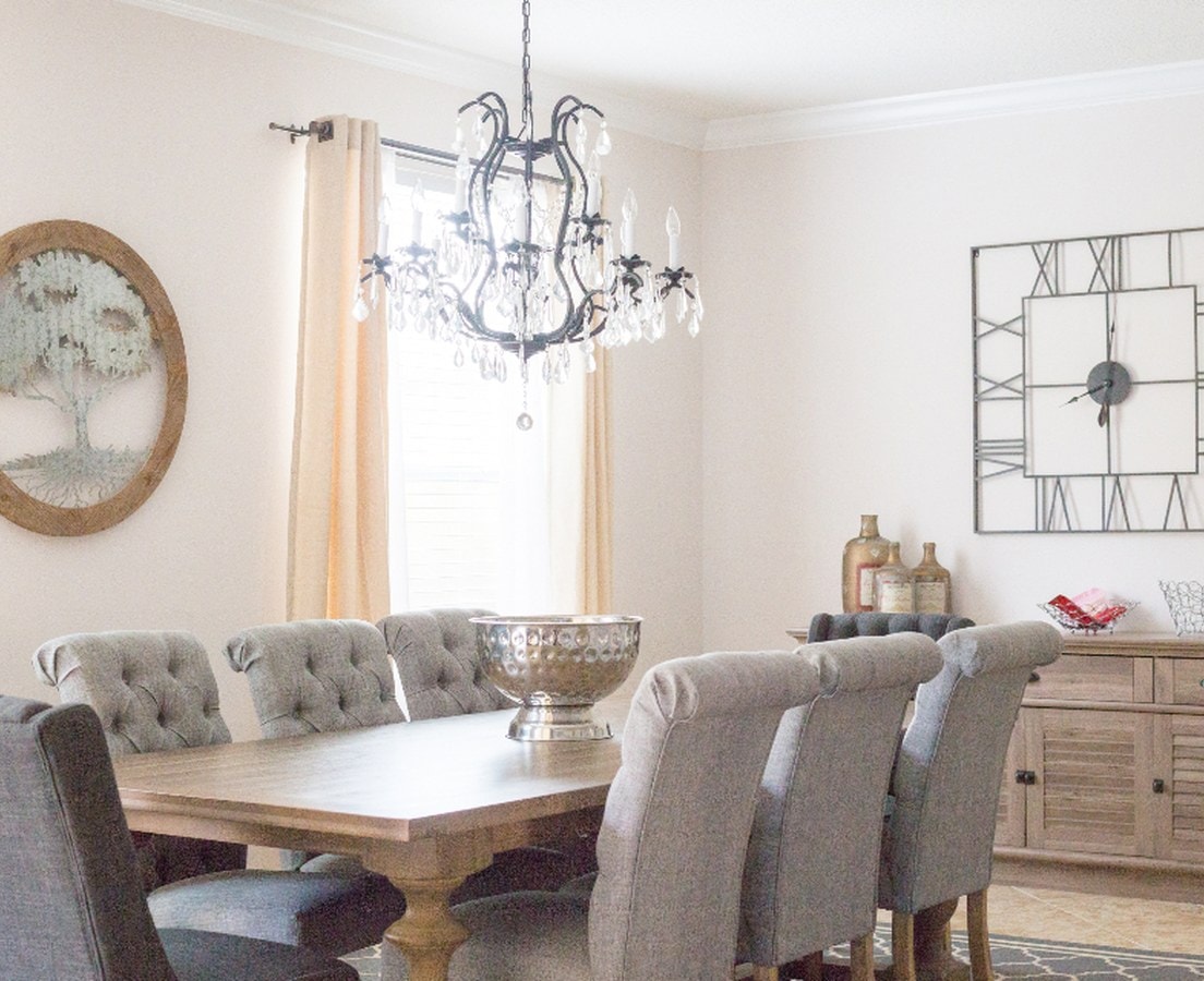 Dining room with a black iron and crystal chandelier over the table