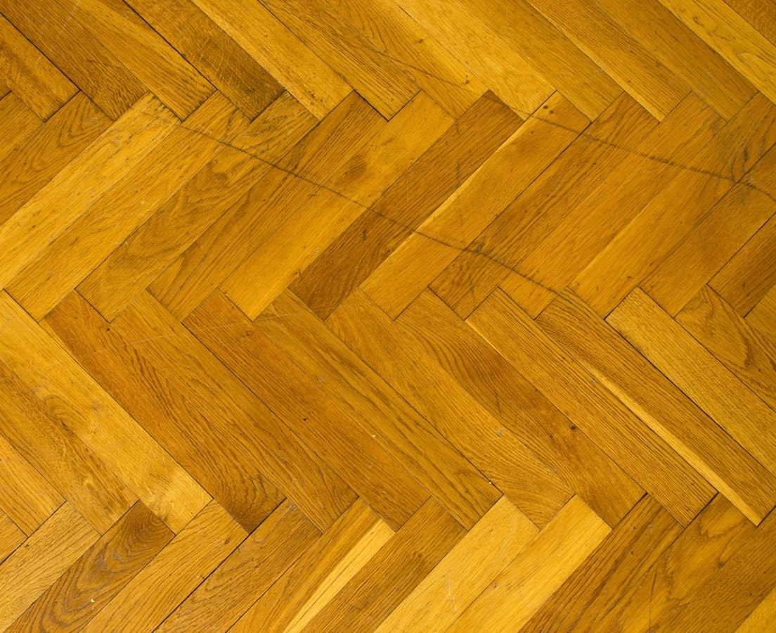 Close-up of oak flooring laid in a herringbone pattern