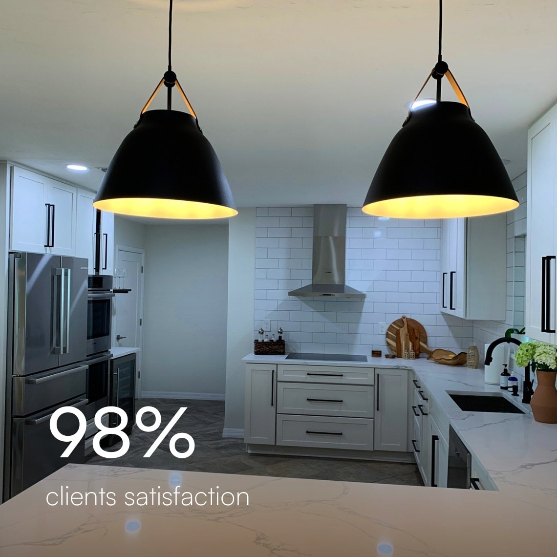 Remodeled kitchen with black pendant lights and a quartz island, 98% client satisfaction