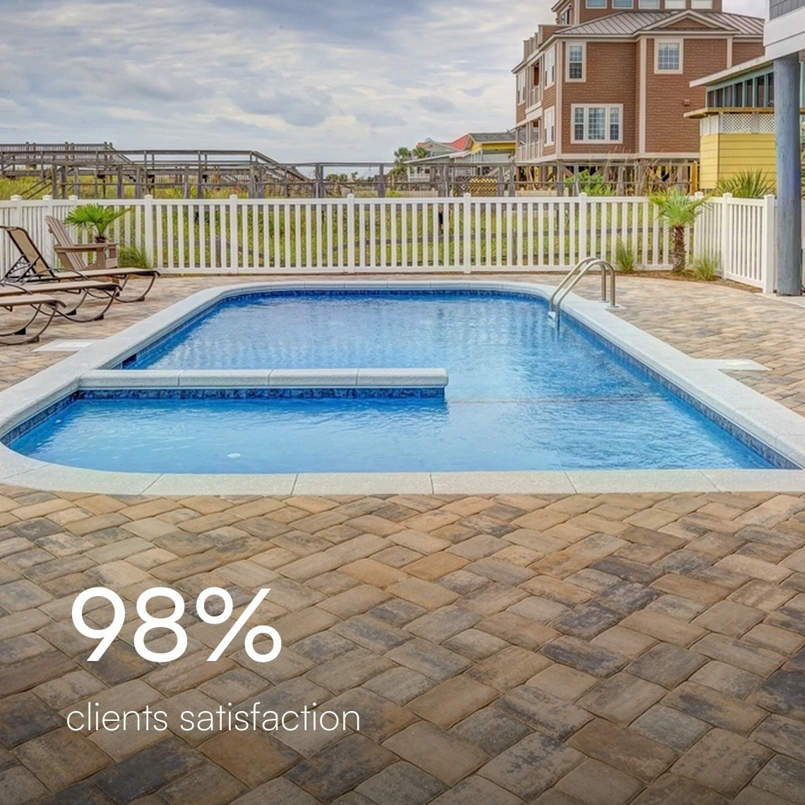 Paver pool deck with lounge chairs beside a coastal home, 98% client satisfaction