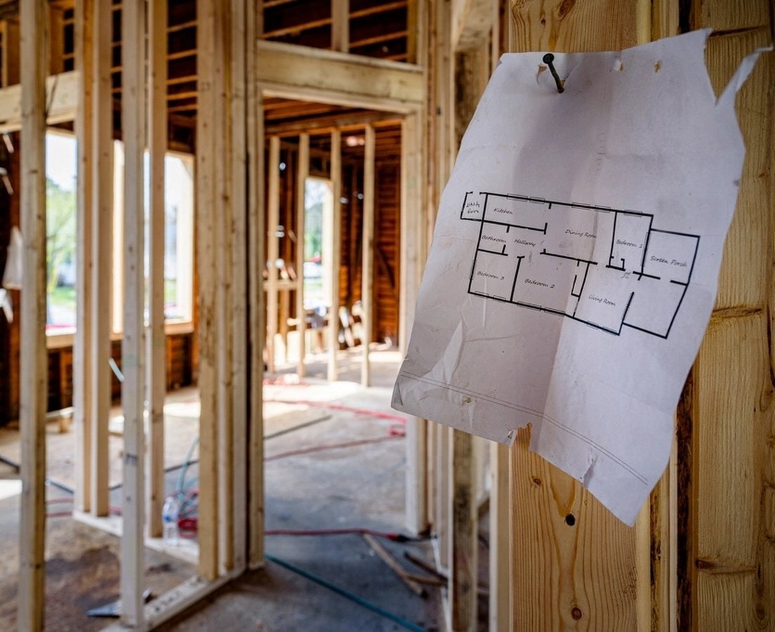 Floor plan nailed to a wall stud inside a framed house under construction