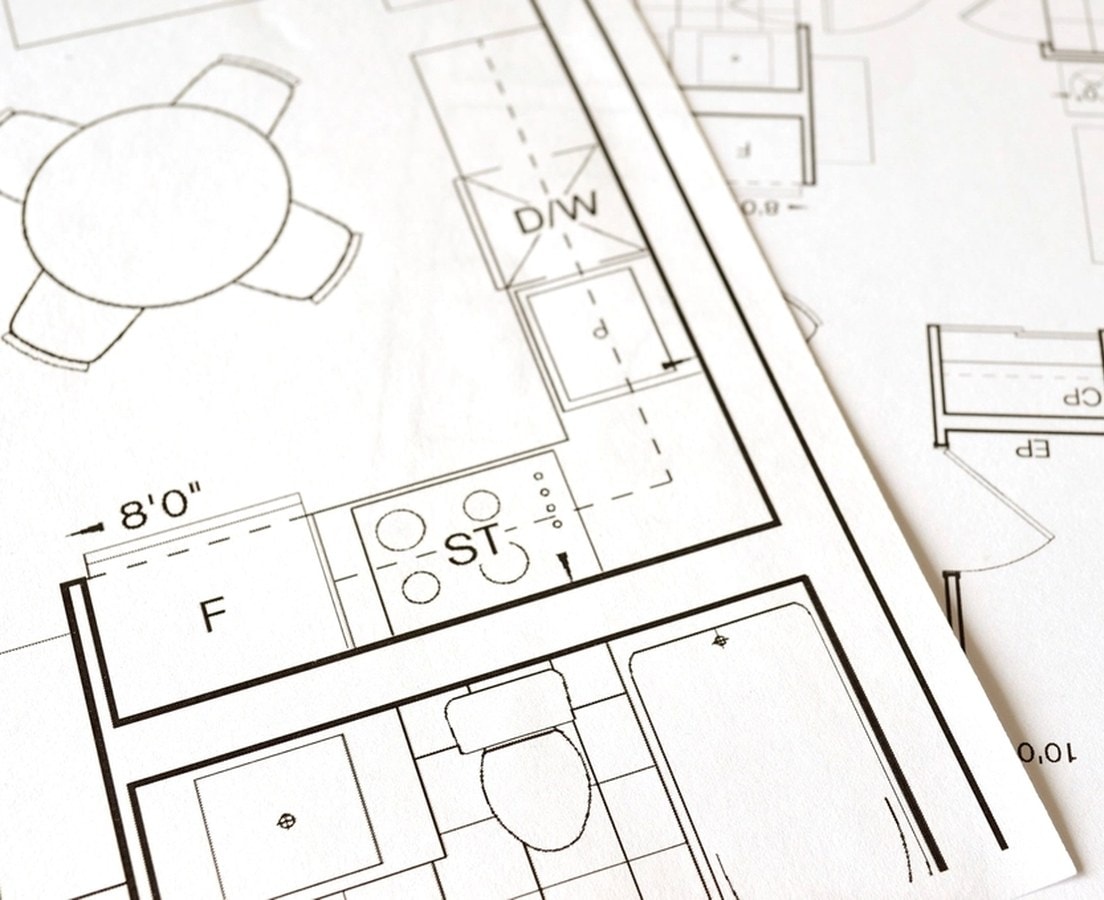 Printed floor plans of a kitchen and bathroom with dimensions and appliance locations
