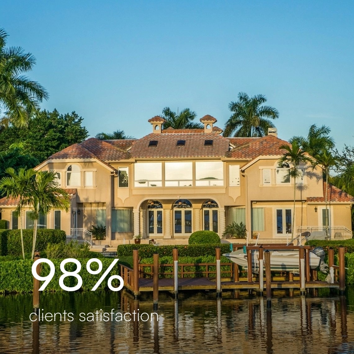 Waterfront Florida home with a clay tile roof, palm trees, and a boat dock, 98% client satisfaction