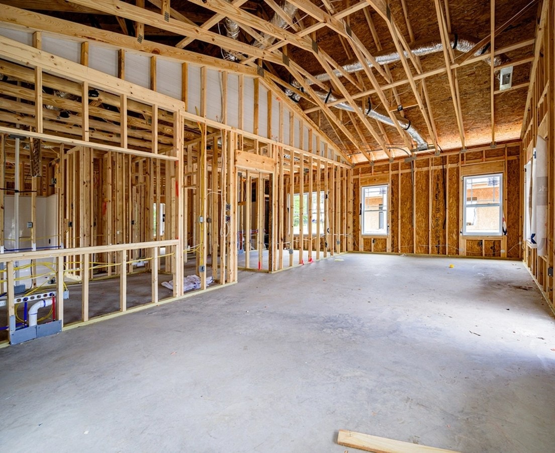 Framed rooms at rough-in, with cable runs through the open stud walls and ductwork overhead